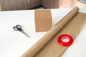 Accessories for packing holiday gifts, scissors and red ribbon photo