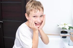 Cute boy washes and laughs photo