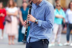 Musician playing with his electric clarinet photo