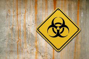 Biohazard sign on a concrete wall photo