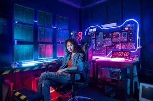 an asian woman programmer is working in her computer room , futuristic technology concept photo