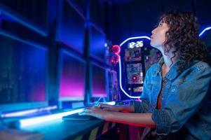 an asian woman programmer is working in her computer room , futuristic technology concept photo