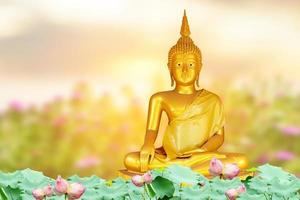 Makha Asanaha Visakha Bucha Day Golden Buddha image. Background of Bodhi leaves with shining light. Soft image and smooth focus style photo