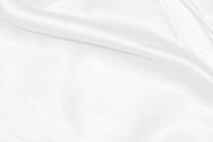 white silk textured cloth background,Closeup of rippled satin fabric with soft waves. photo