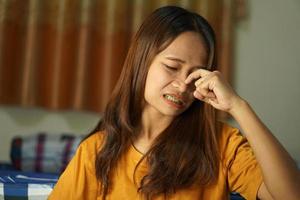Asian woman having itchy nose photo