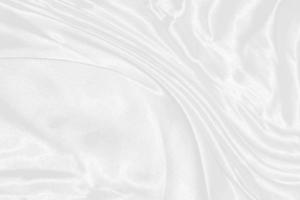 white silk textured cloth background,Closeup of rippled satin fabric with soft waves. photo