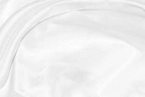 white silk textured cloth background,Closeup of rippled satin fabric with soft waves. photo