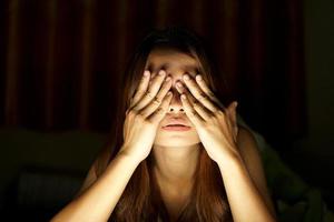 Asian women suffer from eyestrain from looking at computers in low light. watch movies online photo