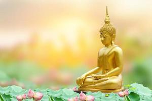 Makha Asanaha Visakha Bucha Day Golden Buddha image. Background of Bodhi leaves with shining light. Soft image and smooth focus style photo