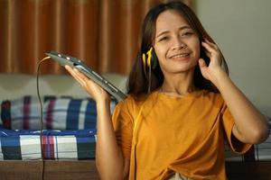 happy asian woman from listening to music photo