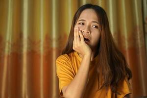 Asian woman on the bed having a toothache photo