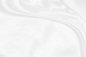 white silk textured cloth background,Closeup of rippled satin fabric with soft waves. photo