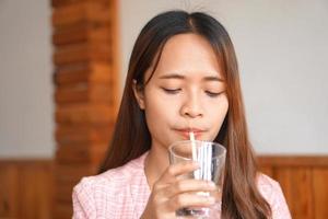 Asian woman drinking cold water to refresh photo