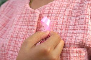 Pink bow on a woman's chest, International Women's Day photo