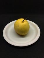 fresh pears on a white plastic plate photo