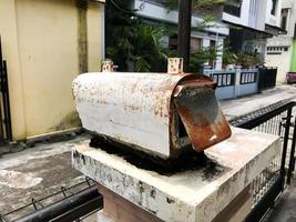 A mailbox that is old and has a lot of rust photo