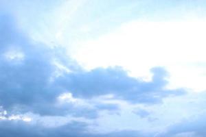 dark blue cloud with white light sky and sun ray with rainbow color reflection background photo