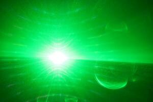 green beam laser beam on dark background photo