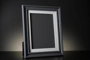 Mockup of black frame in dark interior photo