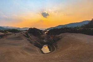 Landscape sunset on the beach sandy with rock and orange sky summer background photo