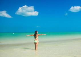 Beautiful young woman on the beach photo