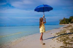 Beautiful little girl on the beach photo