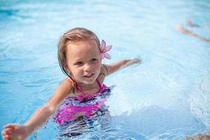 Little girl having fun on the pool photo