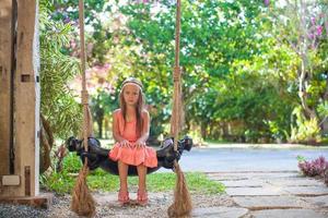 Little girl on the swing photo