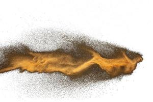 Golden sand explosion isolated on white background. Abstract sand cloud.Sandy fly as wave. photo