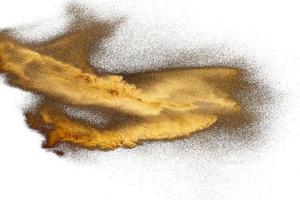 Golden sand explosion isolated on white background. Abstract sand cloud.Sandy fly as wave. photo