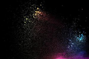 Colorful background of chalk powder. Multicolored dust particles splattered on black background. photo