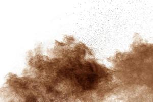 Freeze motion of brown dust explosion.Stopping the movement of brown powder. photo
