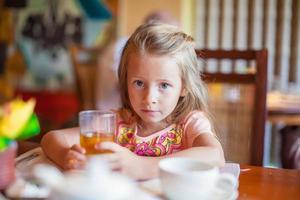 Little girl eating breakfast photo