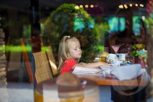 Little girl eating breakfast photo