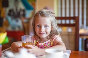 Little girl eating breakfast photo