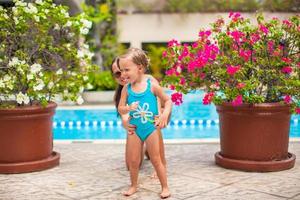 Mother and daughter by potted flowers photo