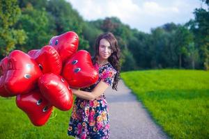 Woman with heart shaped balloons photo