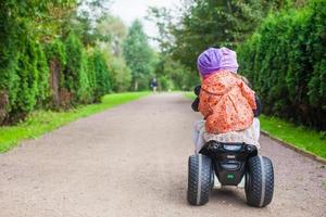 Little girls on a electric motorcycle photo