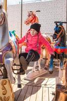 Little girl on a carousel photo