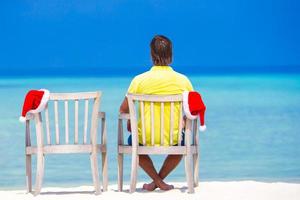 Man seated on the beach photo