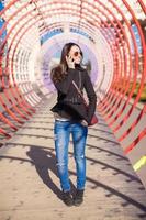 Woman on the phone under a tunnel photo