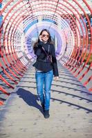 Woman on the phone under a tunnel photo