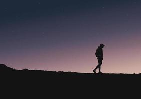 silhouette of a person on a mountain with the sky, vector illustration.