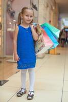 Little girl with shopping bags photo