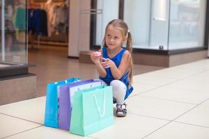 Little girl with shopping bags photo