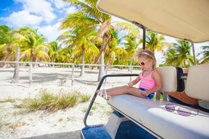 Little girl on a beach car photo