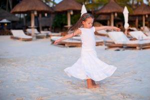 Little girl having fun on the beach photo