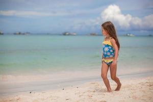 Little girl having fun on the beach photo