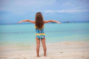 Little girl having fun on the beach photo