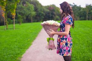 Young woman holding a bouquet photo